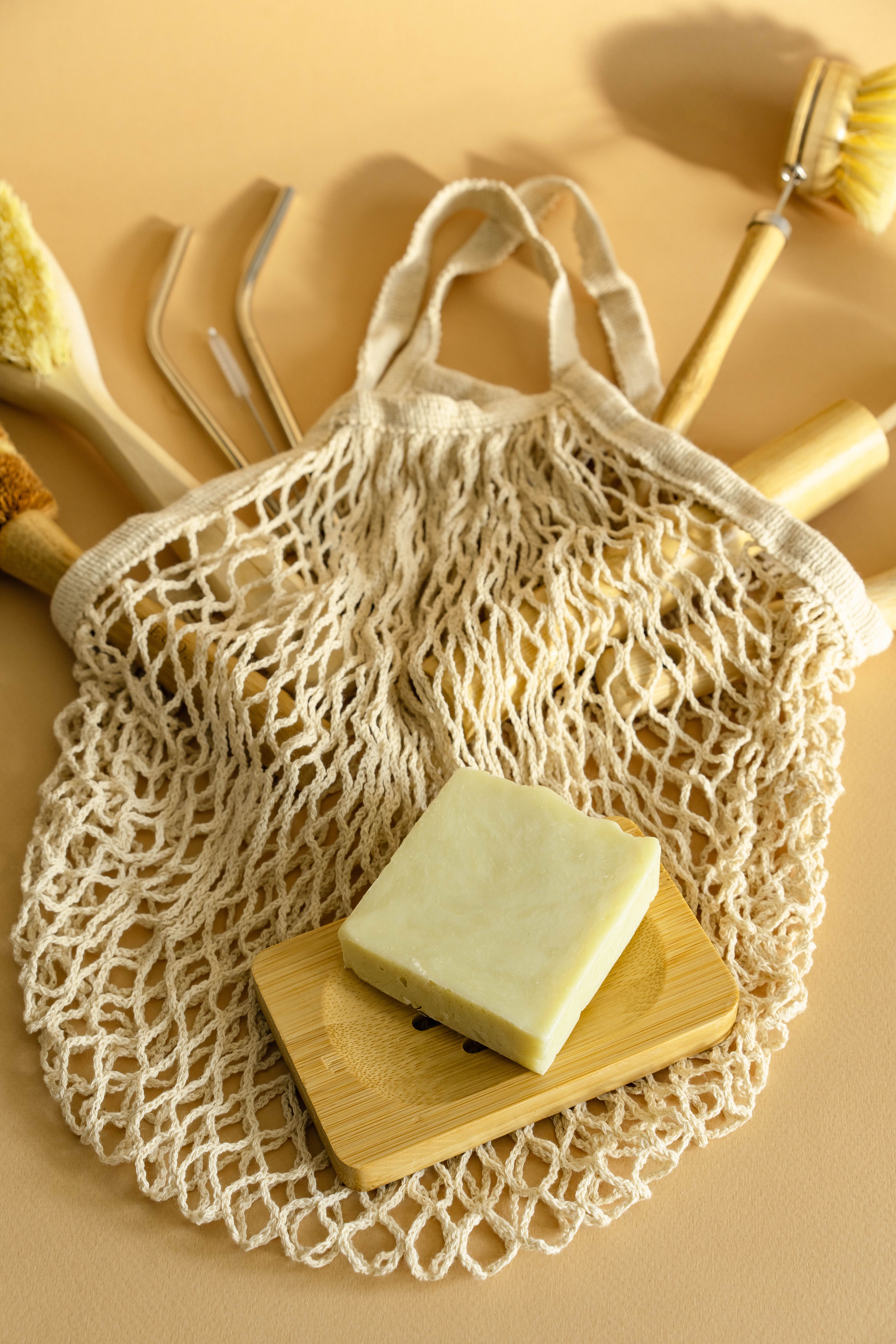 Zero-waste essentials — reusable bag, bamboo soap dish, and natural brushes