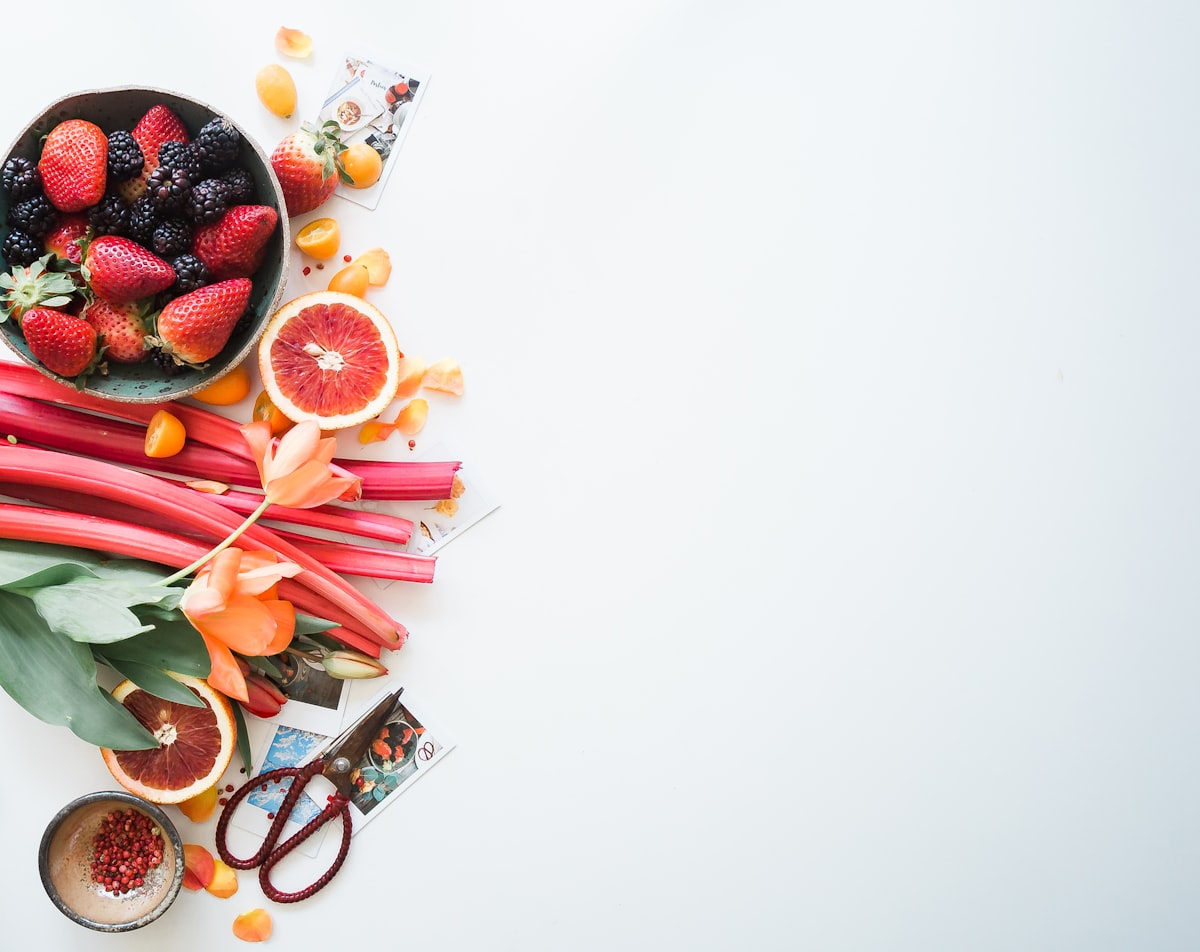 Fresh fruit and flowers on a white table