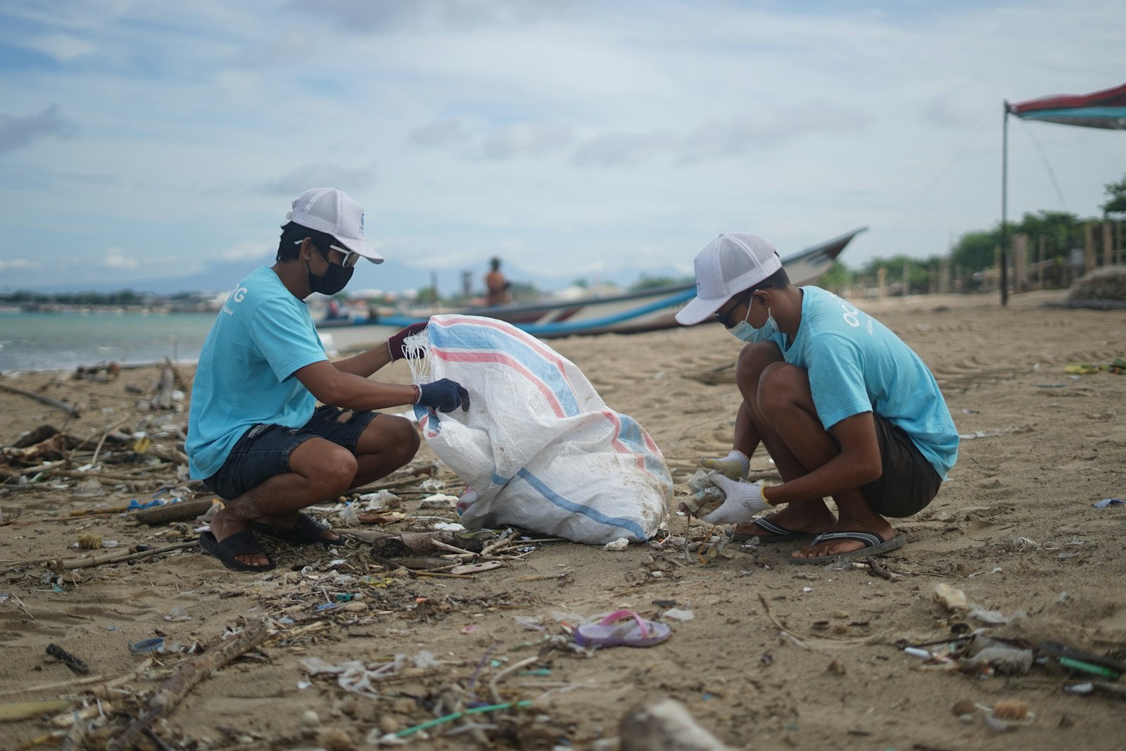 Volunteers collecting plastic trash on a tropical beach